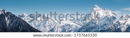 Snowy Mountain Peaks, Large High Altitude Mountains With Blue Sky Background, New Zealand Landscape, Close Up Mountains, Snow Capped Peak, Winter Landscape, Snow Background. Royalty-Free Stock Photo #1737665330