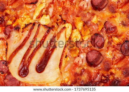 Background of tasty BBQ pizza with ham, bbq sauce, bacon and salami, macro photography, close up view