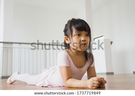 Pretty asian young girl having her online ballet class with her coach stock photo