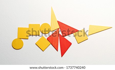 Different colorful shapes wooden on white background. Geometric shapes red, yellow colors, top view. Concept of geometry. Copy space. Children educational logical task. Flat lay.