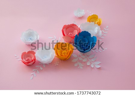 Handmade paper cutout flower set. Blue, pink, yellow and white colors. 