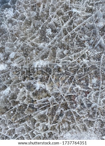 broken gray ice over small rocks