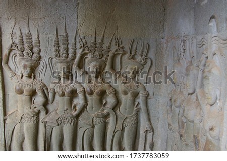 Apsaras bas relief  around Angkor wat wall in many detail of carving.Hairstyle ,headdress,clothes and jewellery carving at apsaras