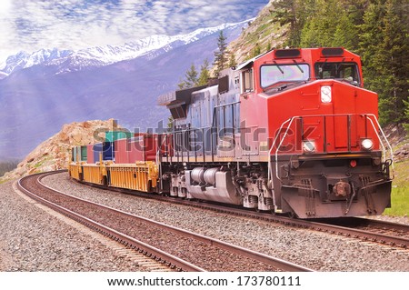 Freight train in Canadian rockies.  Royalty-Free Stock Photo #173780111