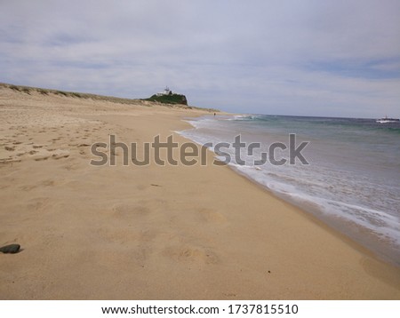 The beach with the white sand on the cloudy day in New Castle, New South Wales, Australia