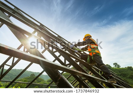 Safety body construction, Working at height equipment. Fall arrestor device for worker with hooks for safety body harness on the roof structure Royalty-Free Stock Photo #1737846932