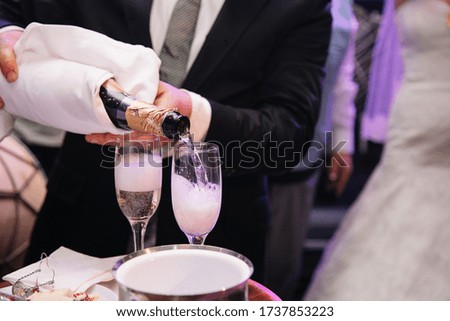 Open bottle of champagne and glasses with champagne, Celebration theme with splashing champagne