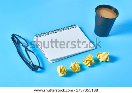 Office workplace with different accessories, tools and gadgets on blue table. Business concept