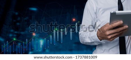 Double exposure of businessman working on tablet with digital marketing virtual chart, Abstract icon, Business strategy concept.