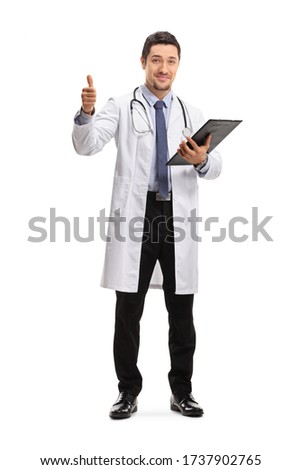 Full length portrait of a young male doctor showing thumbs up isolated on white background 
