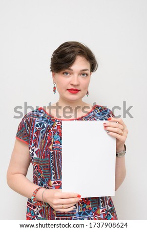 Portrait of a girl with a white sheet on a gray background