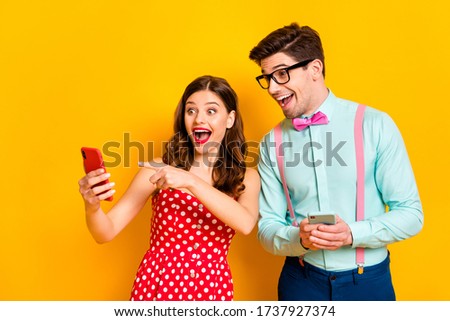 Photo of pretty lady handsome guy shocked direct telephone finger show funny picture wear red dotted dress shirt bowtie isolated yellow bright color background