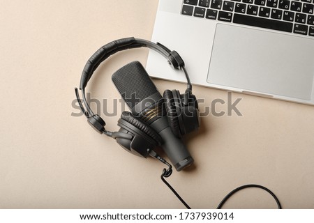 Flat lay composition with Microphone for podcasts  and black studio headphones on brown background with coffee and laptop, learning online education concept.
 Royalty-Free Stock Photo #1737939014