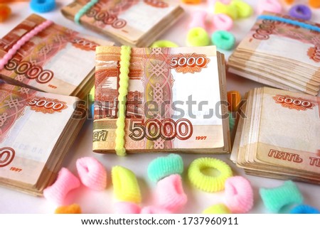 Bundles of banknotes secured with an elastic band. Russian money denomination of five 5000 thousand rubles.