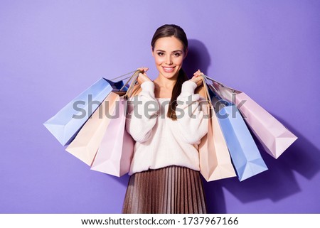 Portrait of nice charming lovely girl enjoy rest relax walk weekend hold many bags she buy in shopping center wear good look brown jumper isolated over violet color background