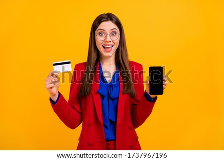 Photo of fancy business lady hold telephone hands offer online way plastic credit card payment wear specs red luxury office blazer blue blouse suit isolated yellow color background