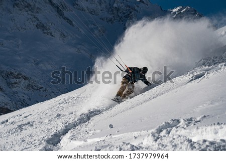 Snowkitng in fresh snow powder in the Alps mountain  Royalty-Free Stock Photo #1737979964