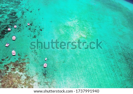 Aerial picture of the east coast of Mauritius Island. Beautiful lagoon of Mauritius Island shot from above. Boat sailing in turquoise lagoon