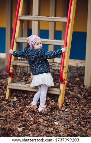 Portrait of beautiful girl in village hides and want to go upstairs, picture isolated on blur background