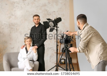 Photographer working with models in studio
