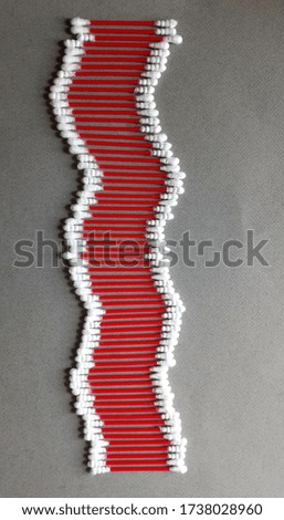 cotton ear sticks on gray paper, design idea. View above, vertical photo 