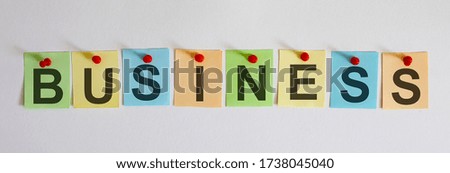 The phrase is written on multi-colored stickers, on the white background. Business concept, strategy, plan, planning.