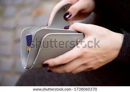 Woman hands with grey wallet purse money credit cards