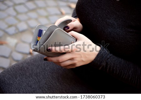 Woman hands with grey wallet purse money credit cards
