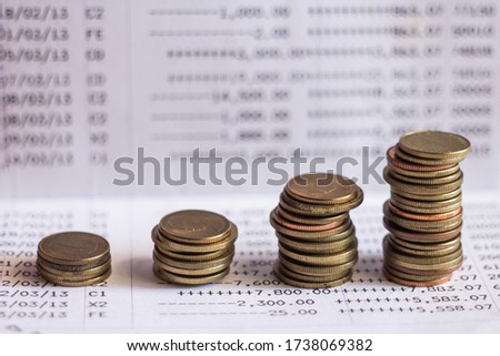 coins on bank account book.  Close up financial report statement monthly book bank account passbook saving money