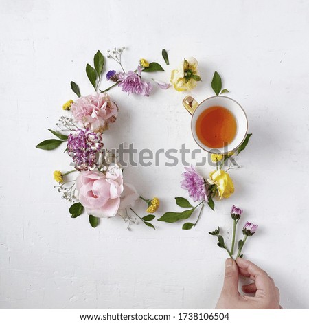 Creative layout of tea and coffee cup with flowers on white background