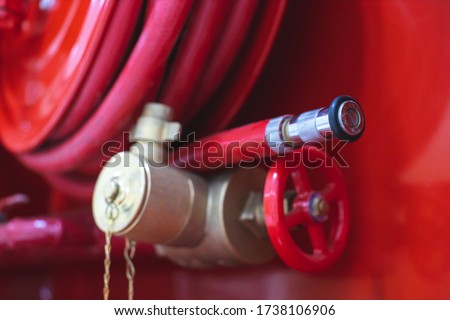 Hydrant with water hoses and fire extinguish equipment. Fire safety equipment in the red box on wall cement . Hydrant with water hoses and fire extinguish equipment / fire hose box .
