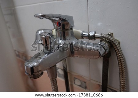 Sliver shining faucet in the toilet