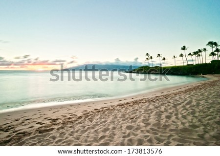 Beautiful ocean beach along west Maui's famous Kaanapali beach. Long exposure at sunset Royalty-Free Stock Photo #173813576