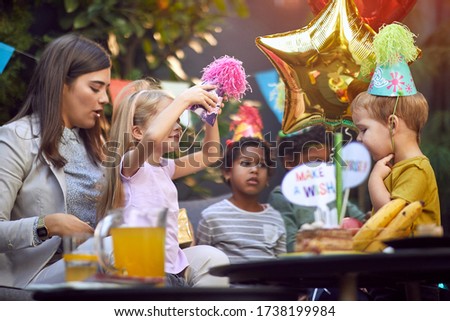 Happy children celebrate  birthday  together at home and have fun.