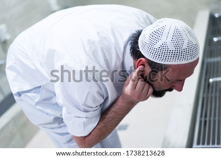 Muslim man taking ablution for prayer. Islamic Religious Rite Ceremony Of Ablution. Young Muslim man perform ablution (wudhu) before prayer. Royalty-Free Stock Photo #1738213628