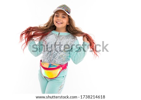Little pretty caucasian girl in a tracksuit, picture isolated on white background