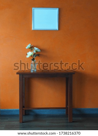 Flower in vase on the table and frame picture decorations,The vintage loft color.