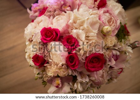 Beautiful festive bouquet of roses and peonies. Delicate flowers. Photo for a postcard.