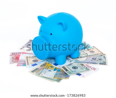 Blue piggy bank on international banknote background