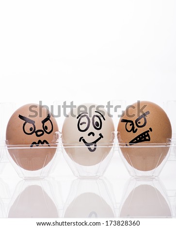  two egg characters displaying angry emotions towards a single white egg