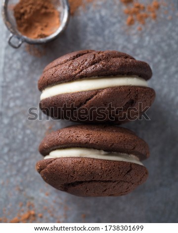 Chocolate whoopie pies on gray stone background