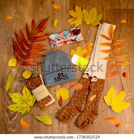 Autumn flat lay, baby clothes, still life with autumn leaves.