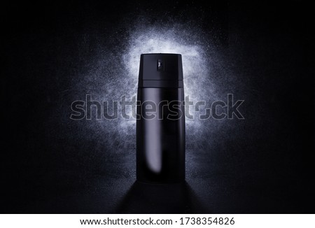 Deodorant in a black metal can on a black background with splashes at the back. Advertising photo of an aerosol antiperspirant. Mocap bottle with spray of water. 3d mockup. Royalty-Free Stock Photo #1738354826
