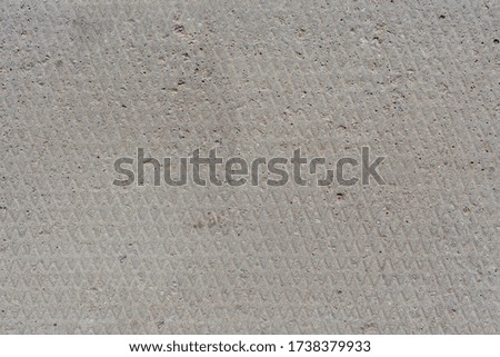 seamless texture and background of old flat dry concrete surface with diamond pattern and signs of light wearing