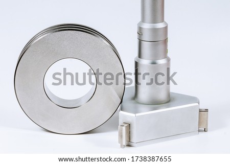 Mechanical Three-Point Internal Micrometer with Setting Ring on a white background.