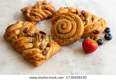 selection of French, Danish pastries with summer fruits on white marble background. Breakfast, morning treat, continental cafe Royalty-Free Stock Photo #1738408430