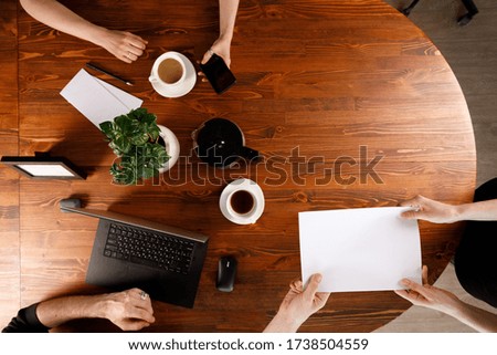 Group of business people working at desk,. Weekday work concept. Office stuff and gadgets nearby.