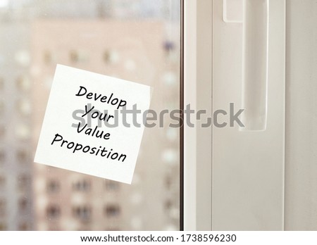 white paper with text "Develop Your Value Proposition" on the window