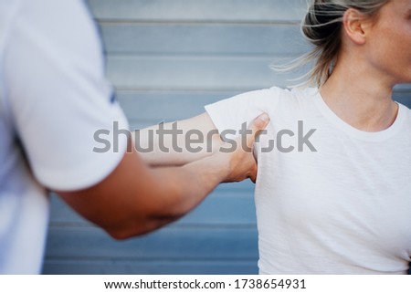 Shoulder dislocation treatment for young female by sports clinician Royalty-Free Stock Photo #1738654931