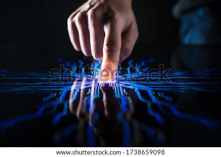 Digitalization Concept: Human Finger Pushes Touch Screen Button and Activates Futuristic Artificial Intelligence. Visualization of Machine Learning, AI, Computer Technology Merge with Humanity Royalty-Free Stock Photo #1738659098
